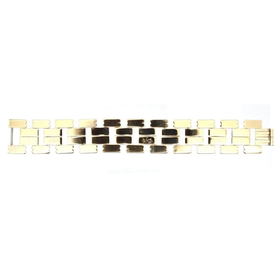 1940s French geometric gold-tone tank bracelet signed by de Farre, showcasing a retro design with moving shapes.