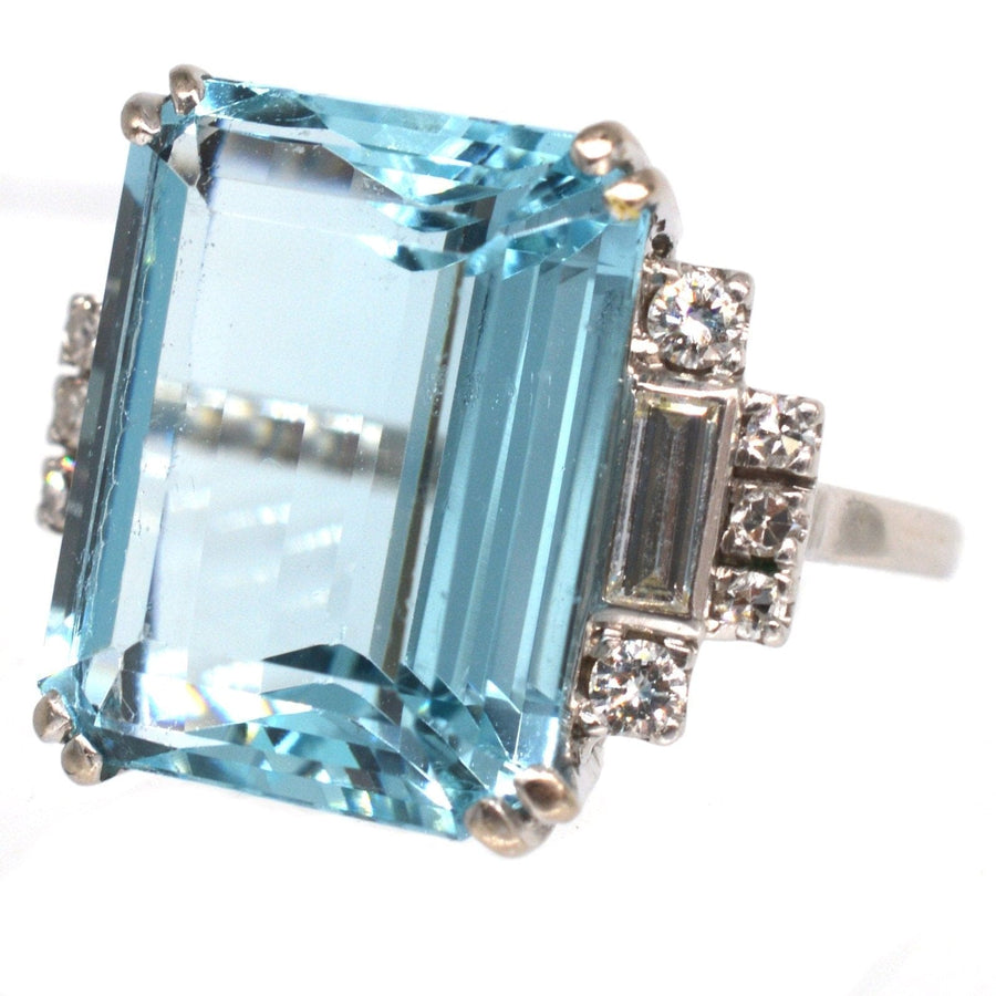 1940s platinum cocktail ring featuring a 16 carat emerald cut aquamarine and diamond accents.
