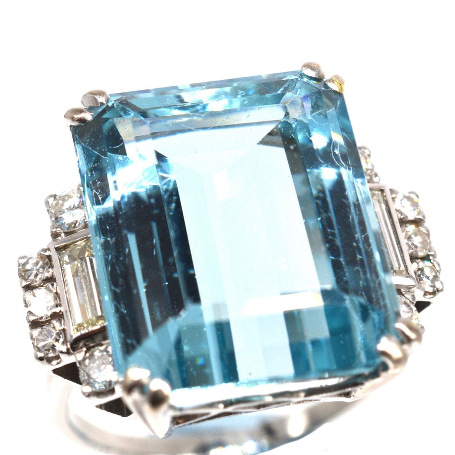 1940s platinum cocktail ring featuring a 16-carat emerald cut aquamarine and diamond accents.