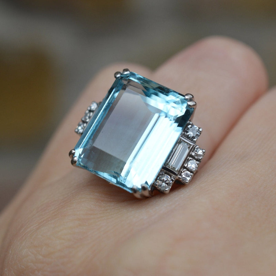 1940s platinum cocktail ring featuring a 16 carat aquamarine and diamond accents, showcasing Art Deco elegance.