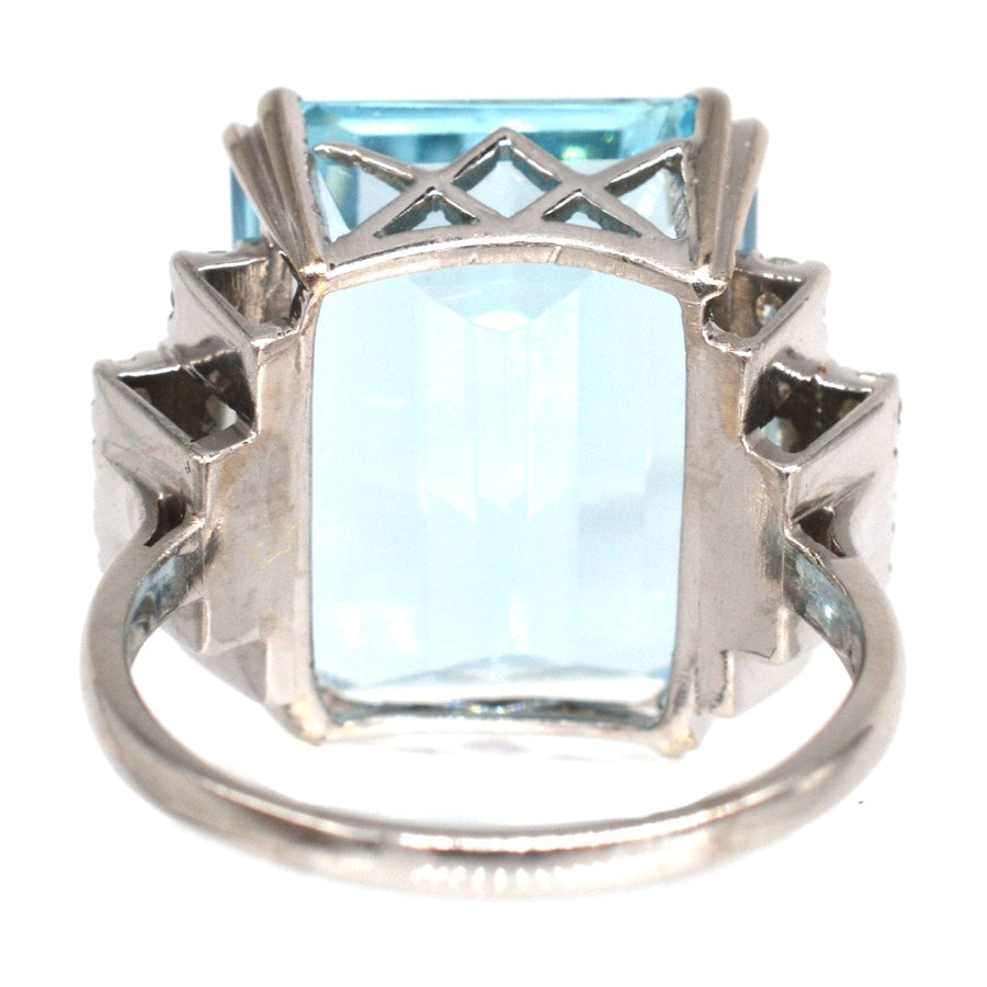 1940s platinum cocktail ring featuring a 16 carat aquamarine and diamond accents, showcasing its stunning emerald cut.
