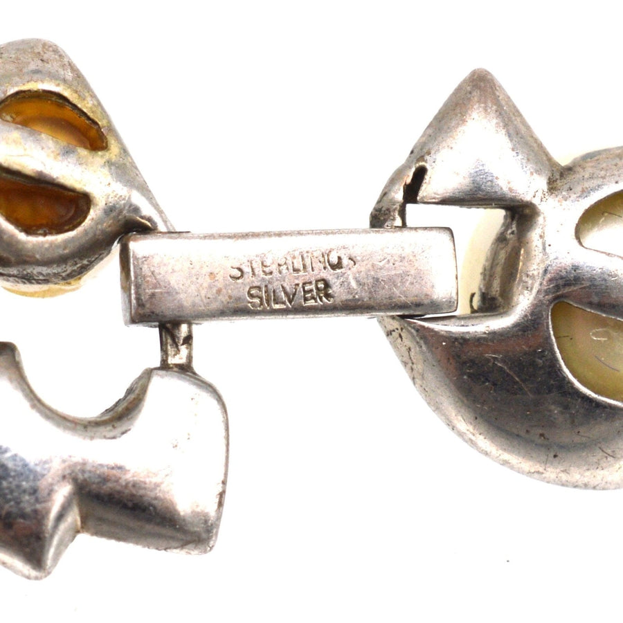 Close-up of a 1940s Retro sterling silver bracelet with yellow accents and clasp detail.