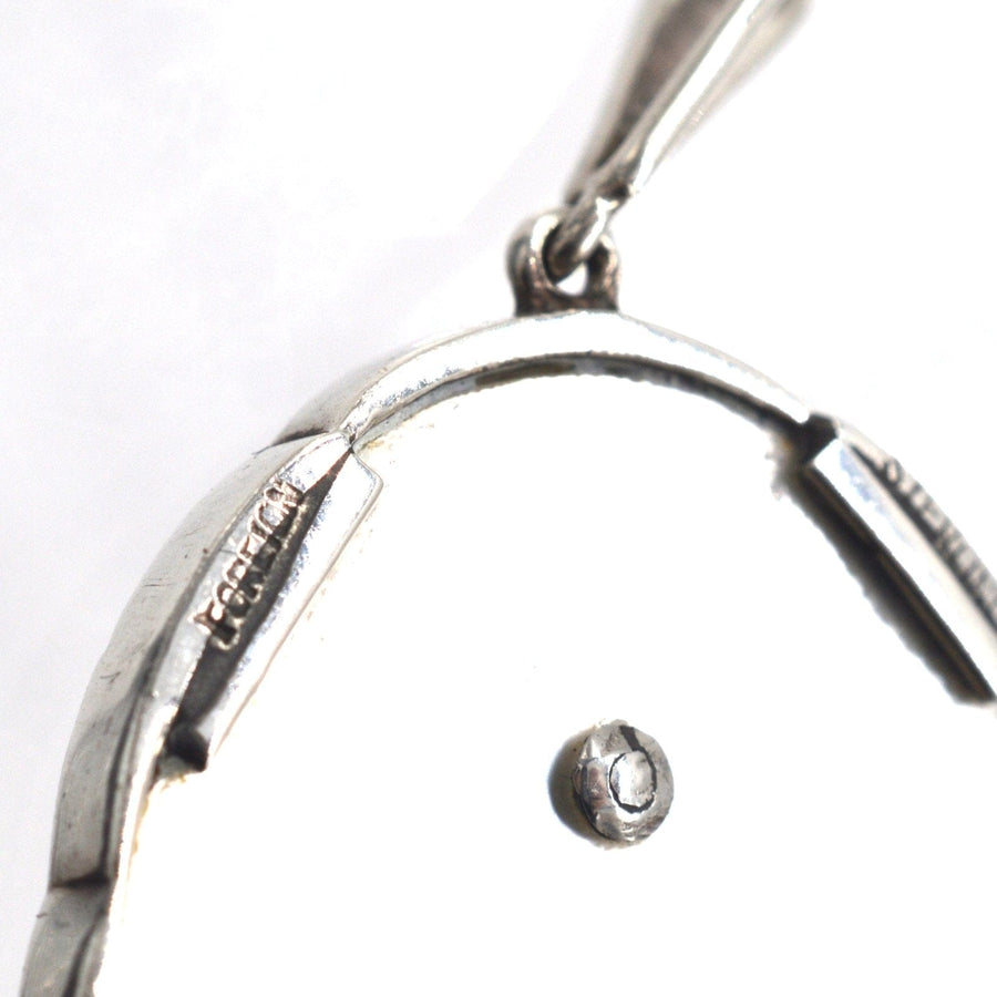Back view of 1940s silver mother of pearl pendant with marcasite, showcasing exquisite craftsmanship and detailing.