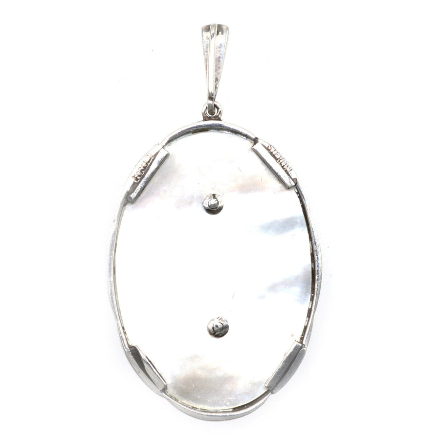 1940s silver pendant with mother of pearl, marcasite accents, featuring a floral design, possibly Austrian origin.