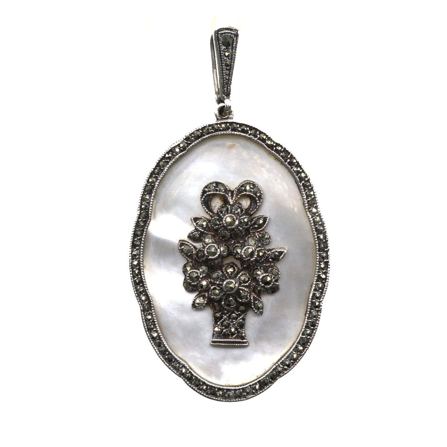 1940s mother of pearl and marcasite pendant featuring a basket of flowers, exquisite vintage design.