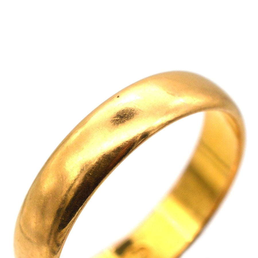1950s 22ct gold wedding ring featuring a classic design, made in Birmingham, showcasing a beautiful butter gold shine.