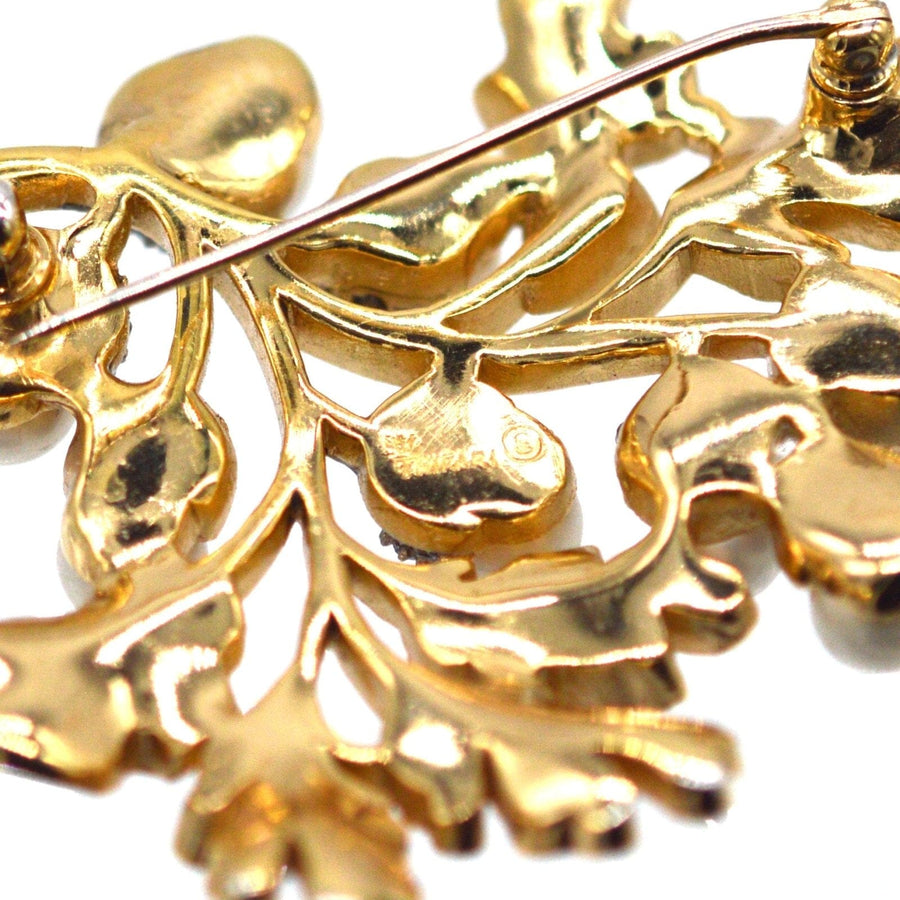 Detailed close-up of Trifari gold-tone oak leaf design showcasing craftsmanship and vintage style.