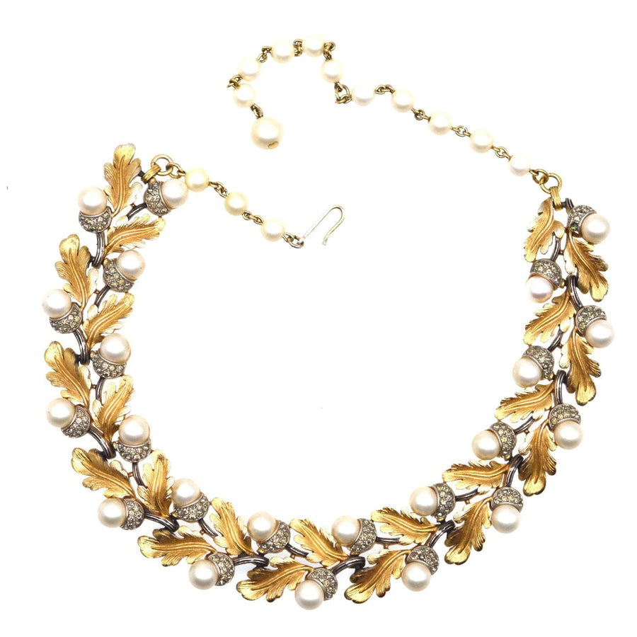 1950s Trifari gold-tone necklace with oak leaf design, faux pearls, and rhinestone accents.