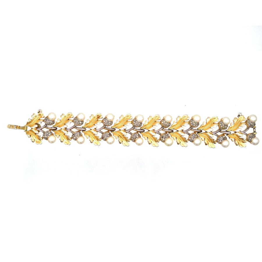 1950s Trifari gold-tone bracelet featuring oak leaves and faux pearls in a stylish design.