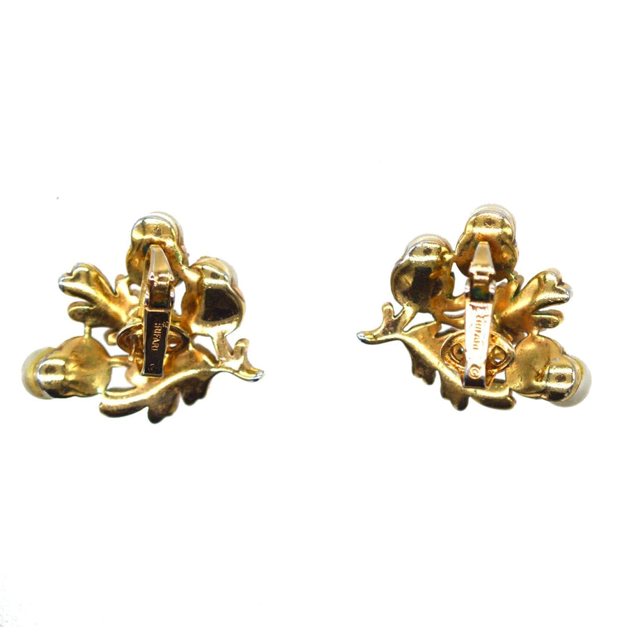 Vintage Trifari gold-tone earrings with oak leaf and acorn design, part of a 1950s jewelry set.