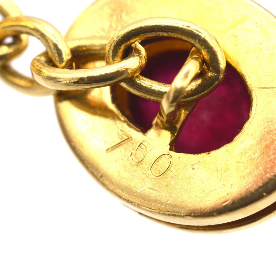 Close-up of 18ct gold cufflink featuring a natural unheated cabochon ruby, showcasing the craftsmanship and quality.