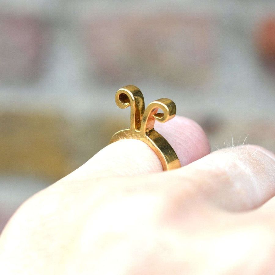 1960s 18ct gold Aries ring by Walter Schluep worn on a finger, showcasing the intricate design and zodiac symbol.