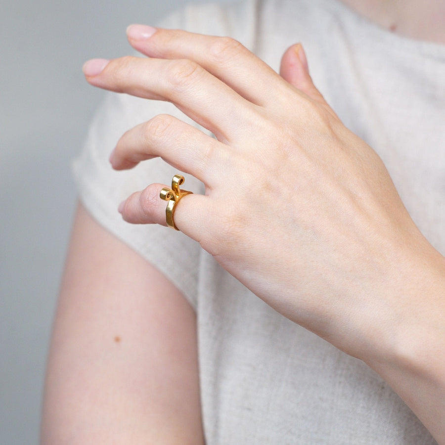 Model wearing a 1960s 18ct gold Aries ring by Walter Schluep, showcasing its unique design.