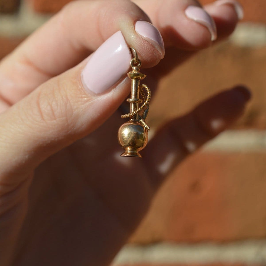 1960s 9ct gold hookah pipe charm held in hand, vintage Shisha pendant, travel souvenir jewelry.