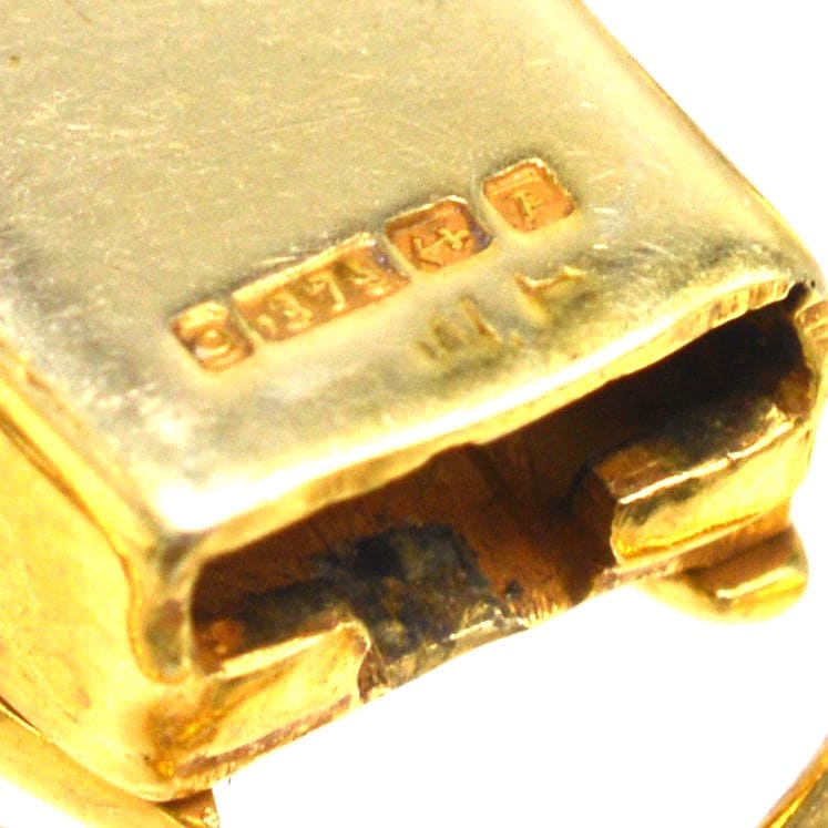 Close-up of 1960s 9ct gold bracelet clasp showing hallmark and quality marks.