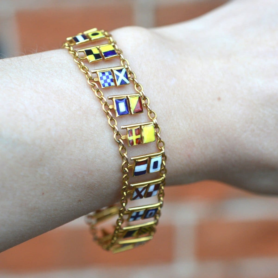 1960s 9ct gold nautical bracelet with colorful maritime signal flags representing the full alphabet and numbers.