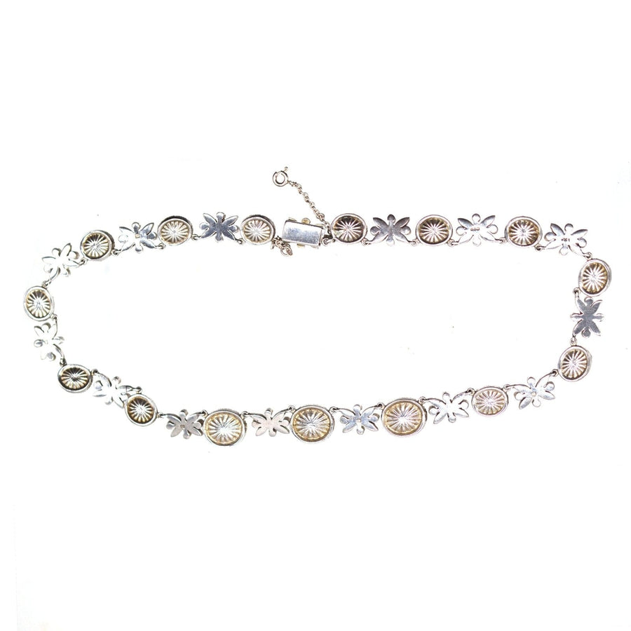 Vintage silver necklace featuring floral motifs and oval accents, perfect for adding elegance to any outfit.