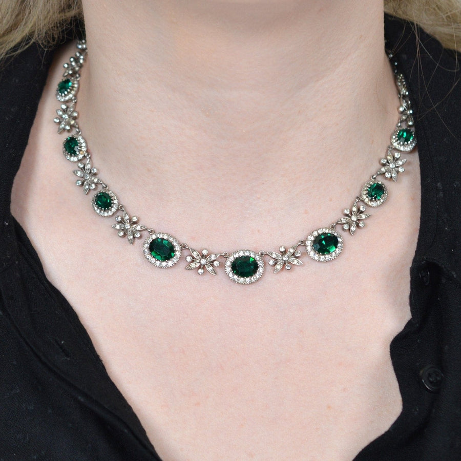 1960s green tourmaline paste necklace worn by a model, showcasing intricate floral designs and sparkling accents.