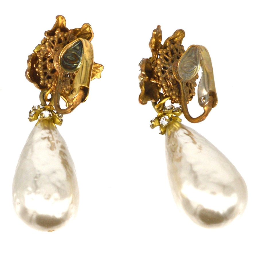 1960s Miriam Haskell faux pearl earrings with gold accents, showcasing vintage elegance and collectable design.