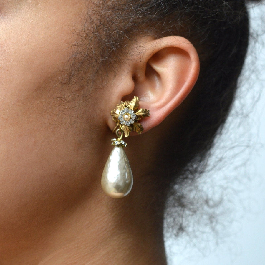 Vintage 1960s Miriam Haskell faux pearl earrings showcasing floral design and large pear-shaped pearl drop.