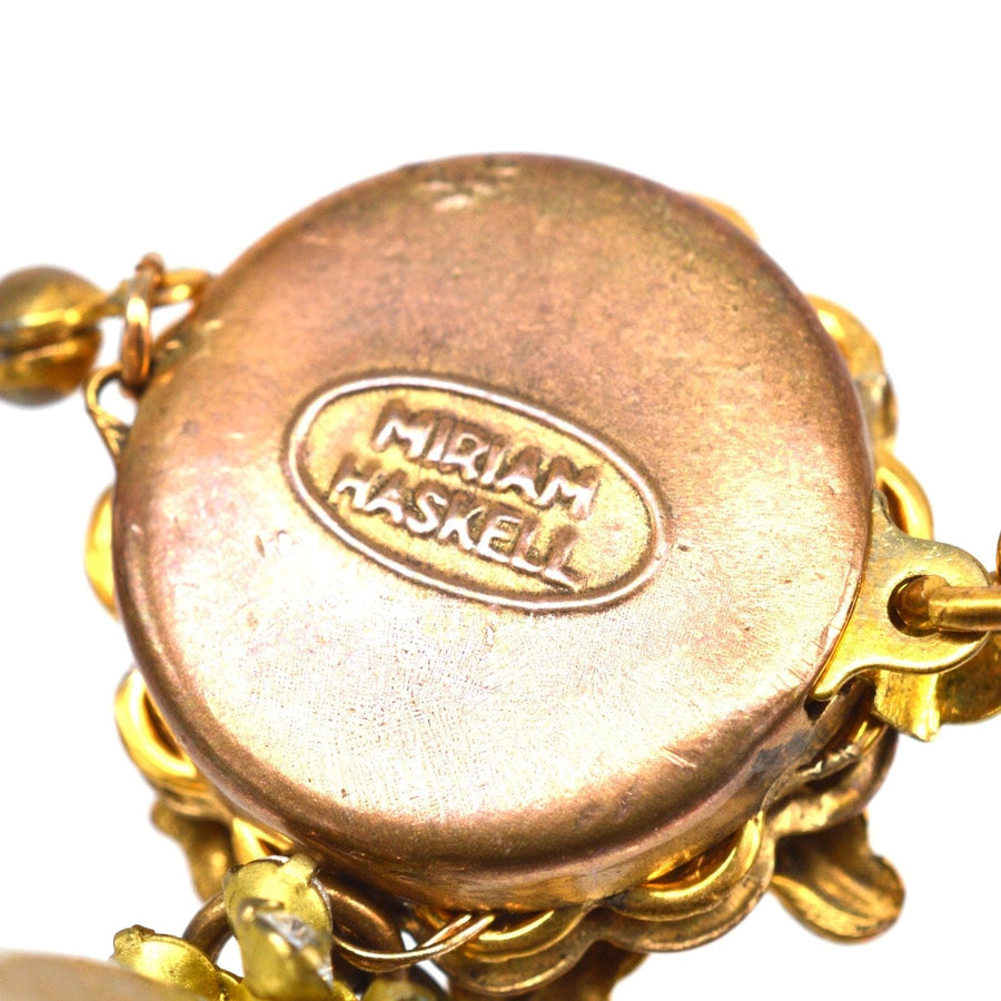 Close-up of Miriam Haskell signature on vintage necklace, showcasing quality craftsmanship.