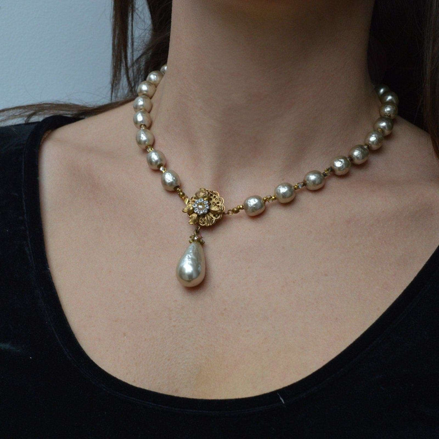 1960s Miriam Haskell faux pearl necklace featuring a floral design with a drop pearl.