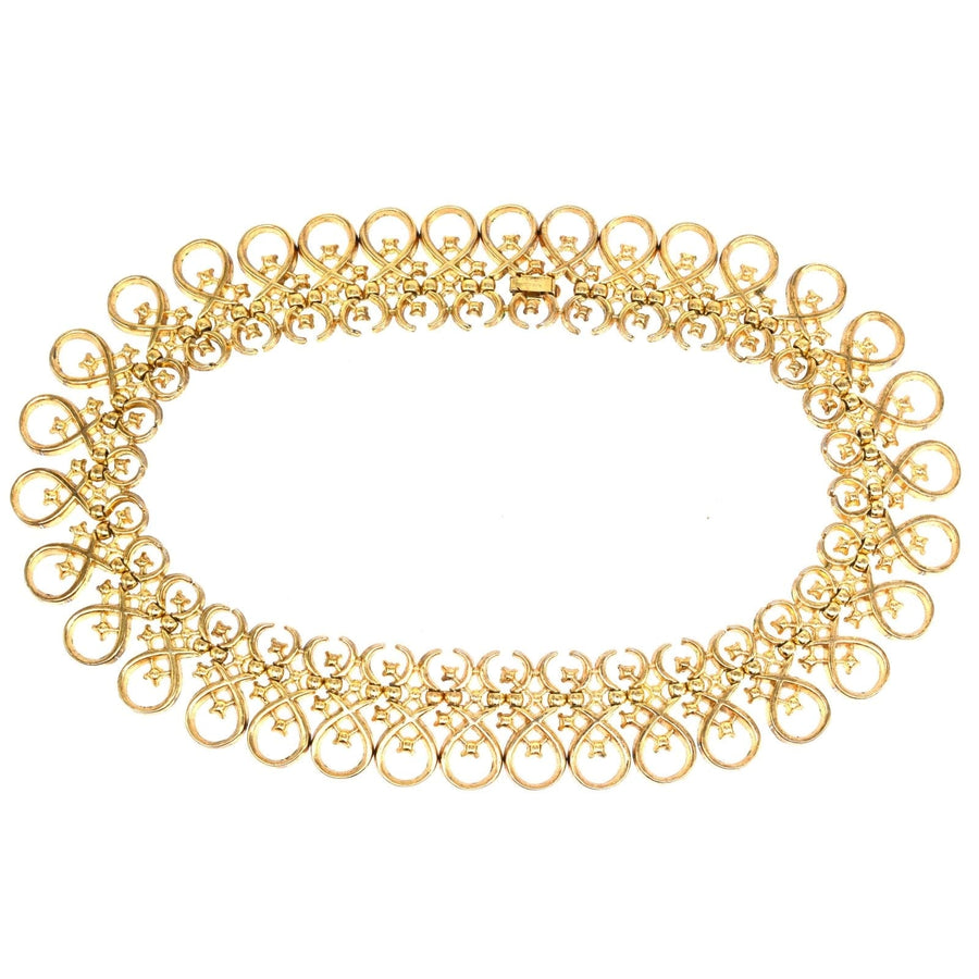 1960s Trifari gold-tone necklace with paste gems, featuring interlinked swirling designs, vintage jewelry.