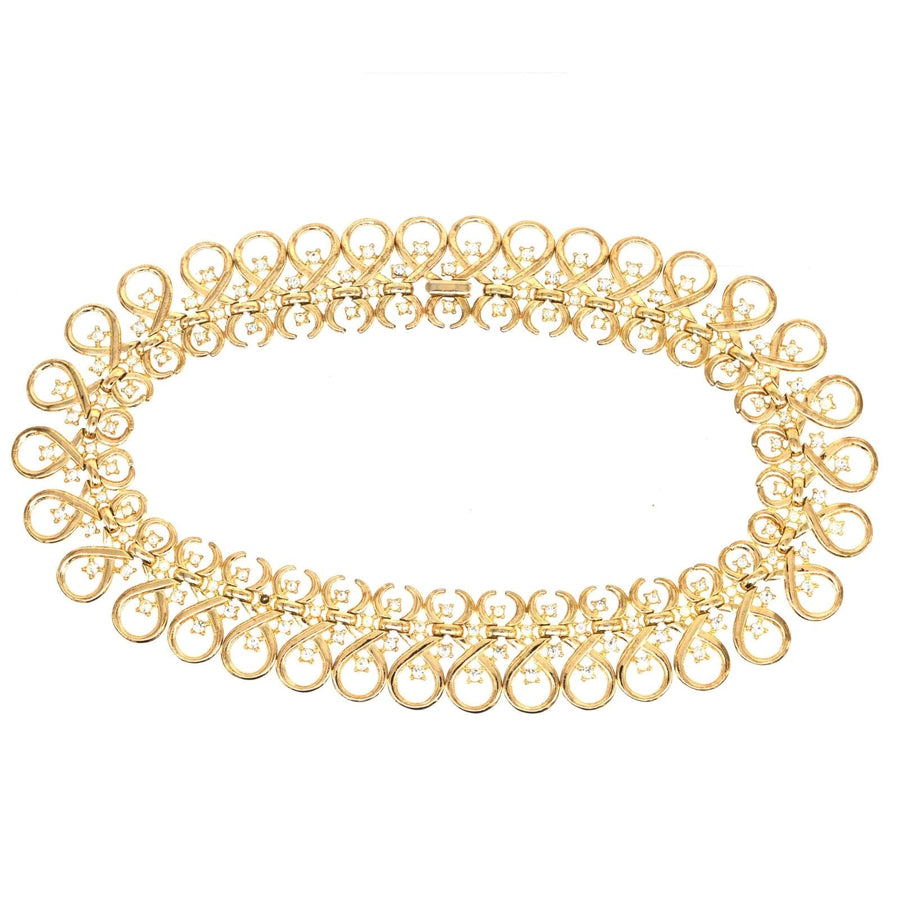 1960s Trifari gold-tone necklace with interlinked swirl design and diamond pastes, showcasing vintage elegance.