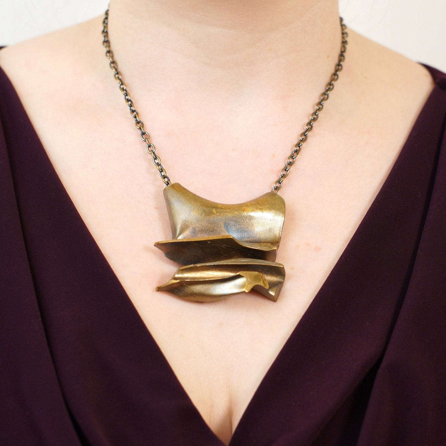 1970s Lapponia Flame Bronze pendant brooch by Björn Weckström featuring an industrial design on a chain.