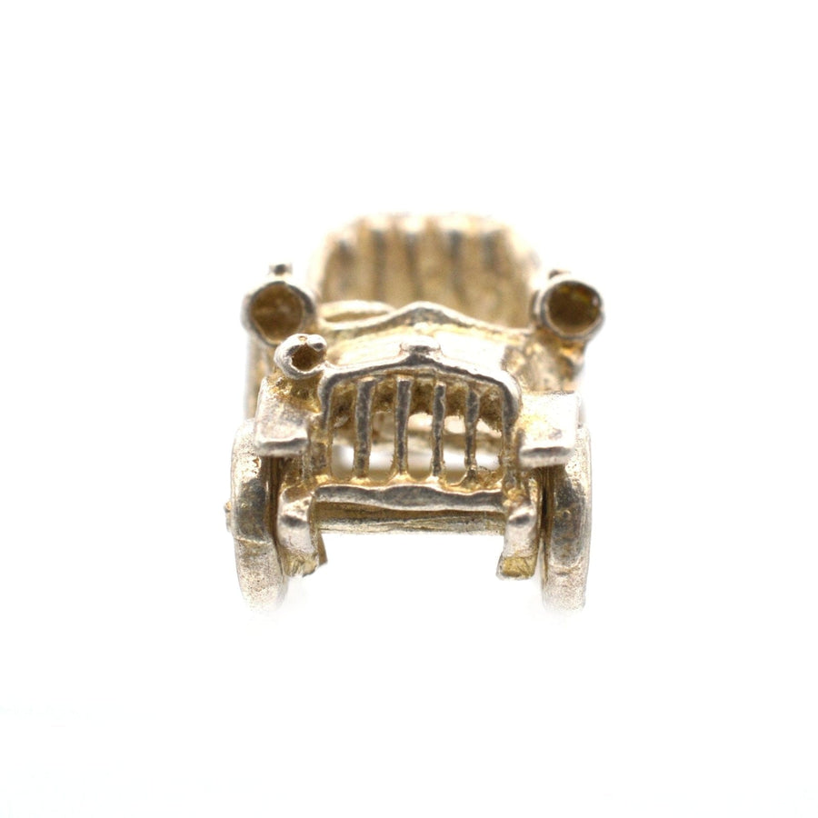 Vintage 1970s silver car charm pendant with movable wheels, reminiscent of a classic Riley model.