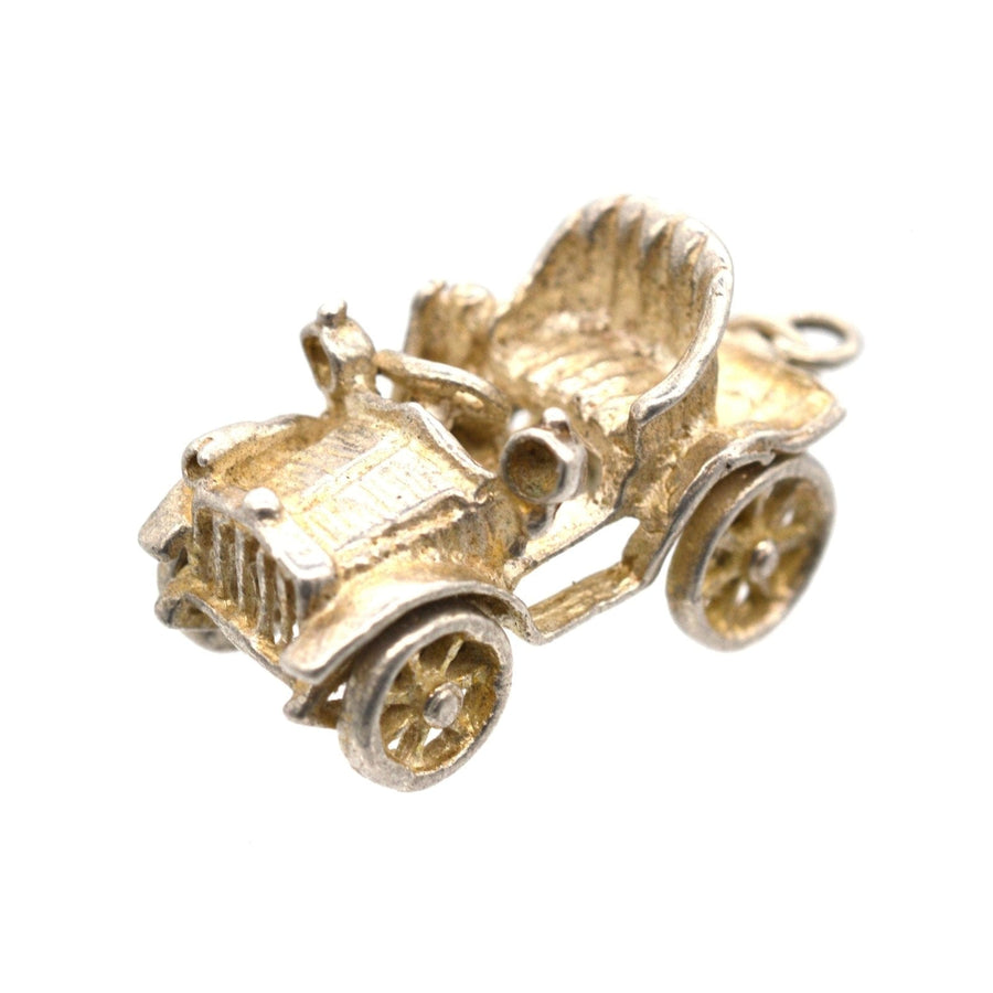 Vintage 1970s silver car charm pendant with moving wheels, perfect for nostalgic jewelry lovers.