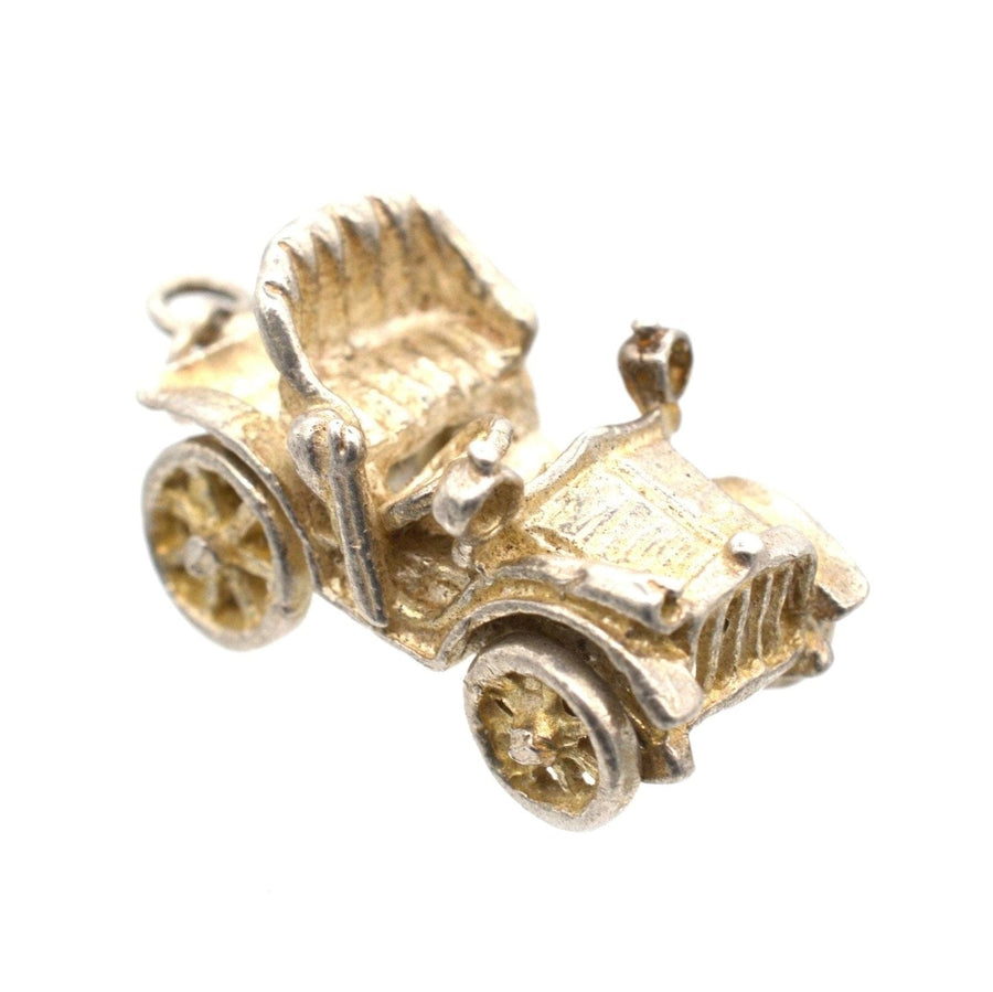 Silver vintage car charm and pendant from the 1970s with movable wheels, resembling a classic Riley.