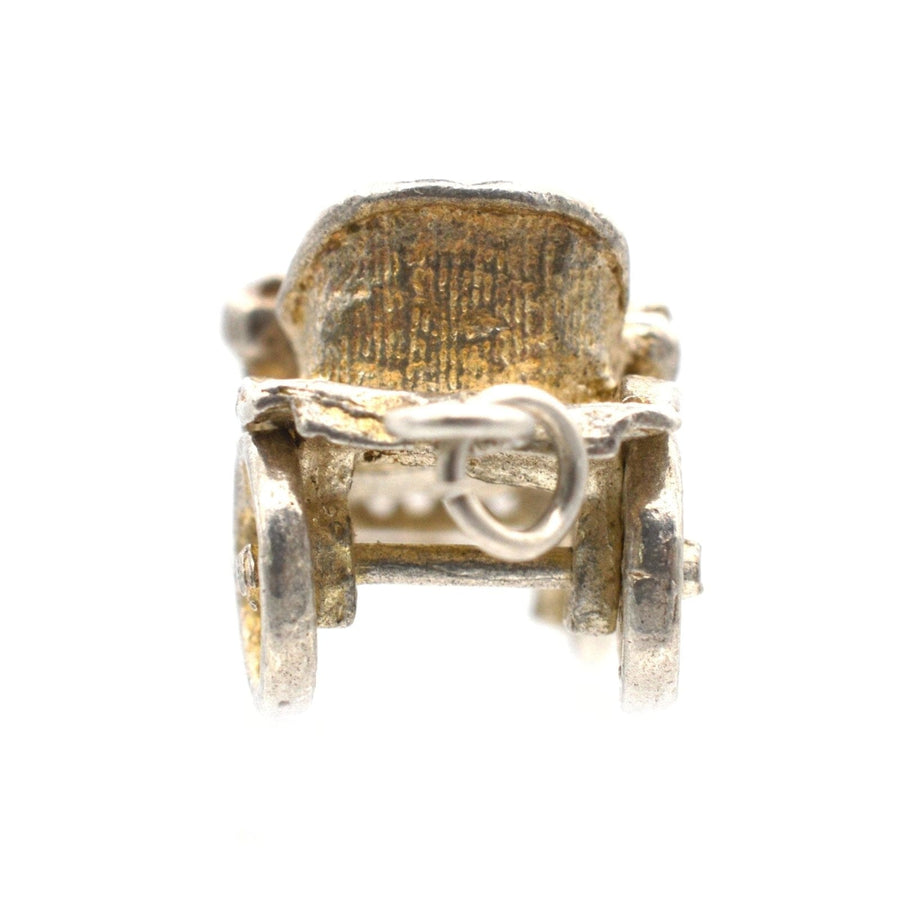 Vintage silver car charm pendant from the 1970s with moving wheels, perfect for collectors and jewelry lovers.