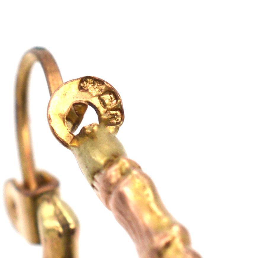Close-up of 1990s vintage 9ct gold hoop earrings with bamboo texture design, perfect for everyday wear.
