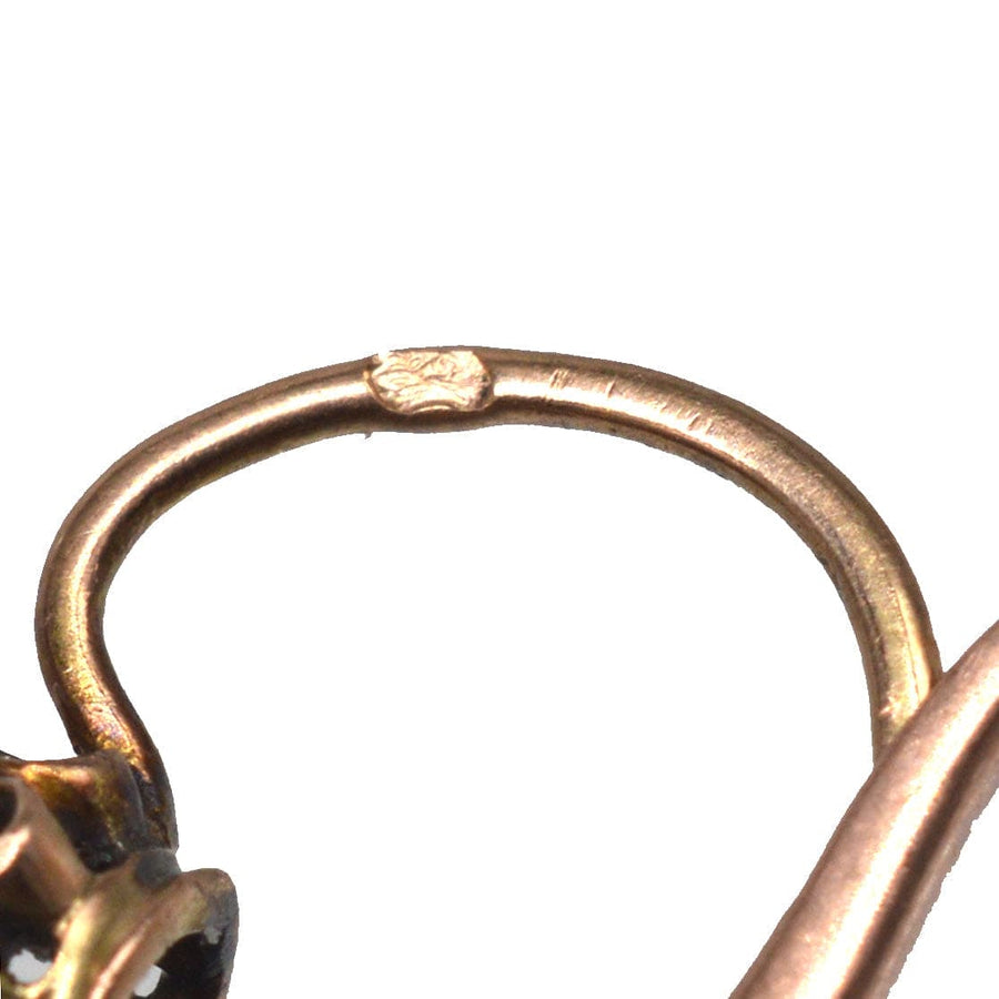 Close-up of 19th century 18ct gold earring hook showcasing rose cut diamond design and craftsmanship.