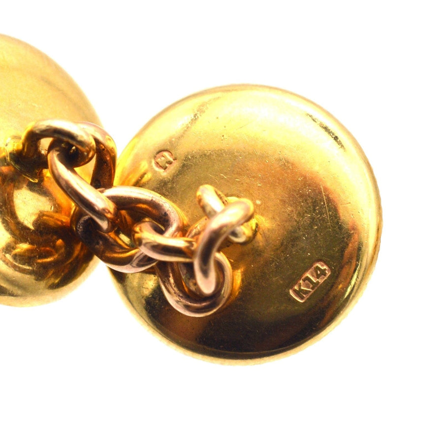 Close-up of 14ct gold cufflink showcasing chain link design and engraved details, representing vintage elegance.