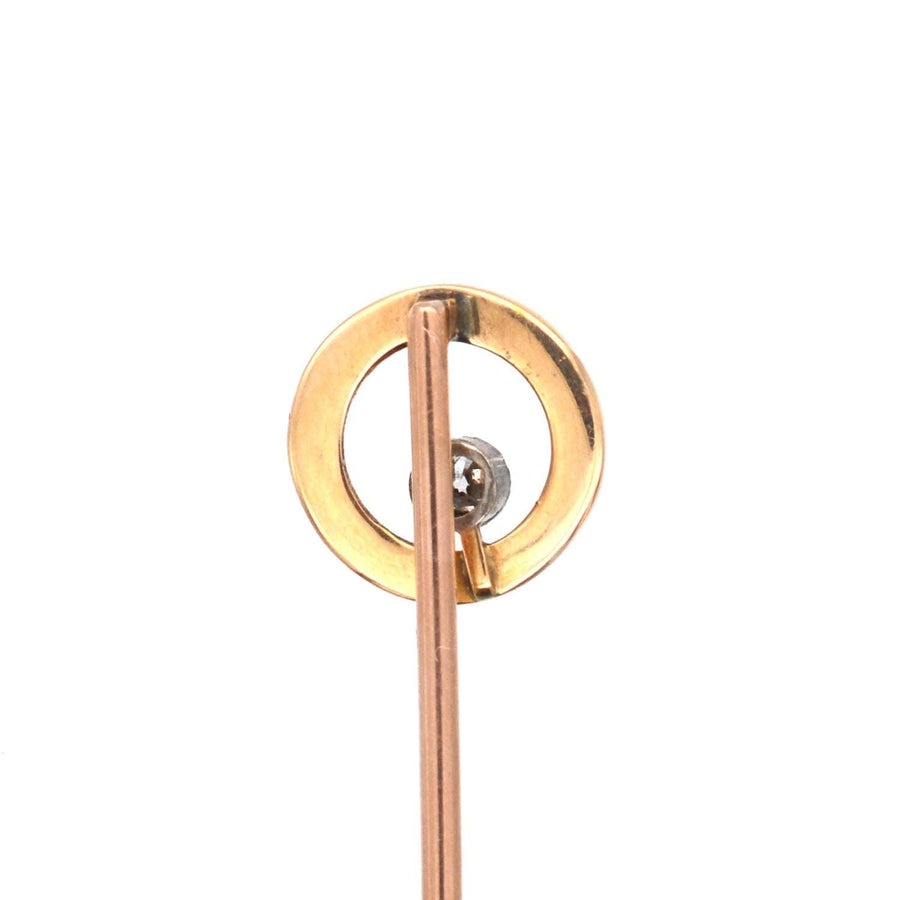 Art Deco 14ct gold and diamond circular tie pin with sleek design and suspended diamond centerpiece.