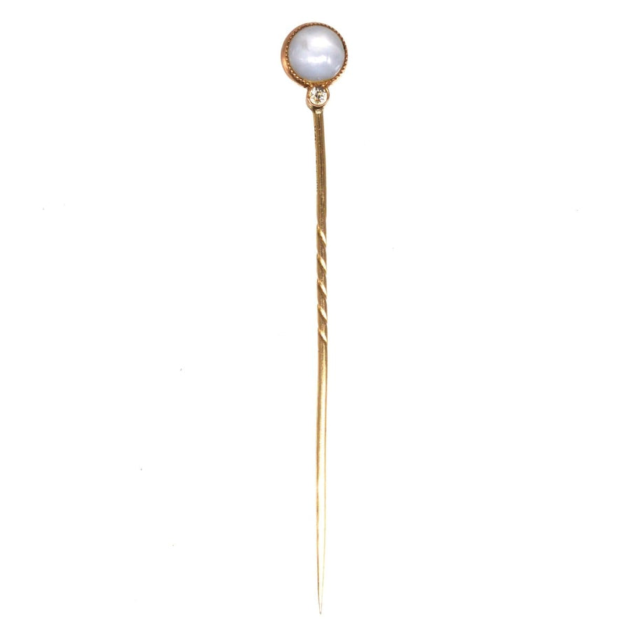 Art Deco gold hairpin with a round pearl top and sparkling diamond, vintage style hair accessory.