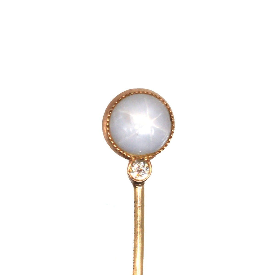 Art Deco gold tie pin featuring a star sapphire cabochon and diamond accent by Shreve & Co.