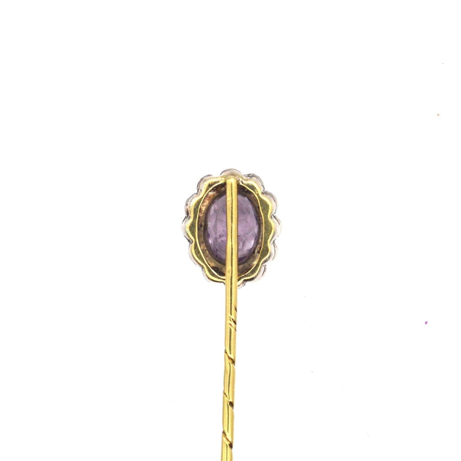 Art Deco 18ct gold tie pin featuring a central amethyst and white paste cluster, crafted between 1915-1925.
