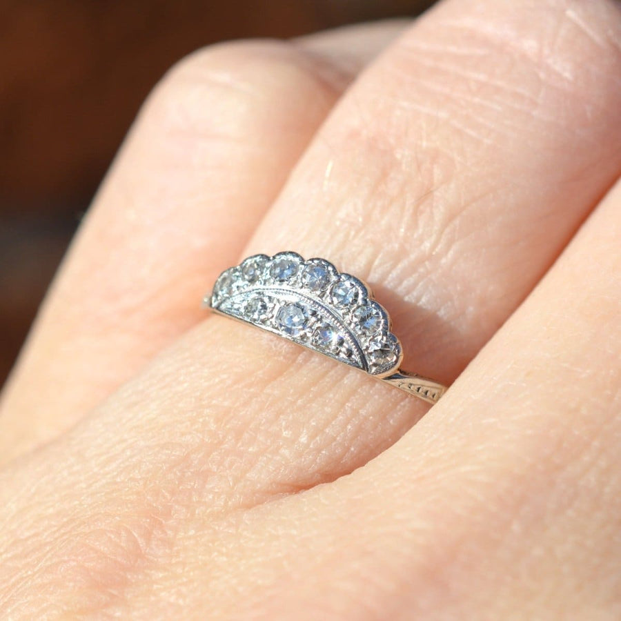 Art Deco 18ct gold and platinum diamond tiara ring worn on finger, showcasing elegant design and sparkling gems.