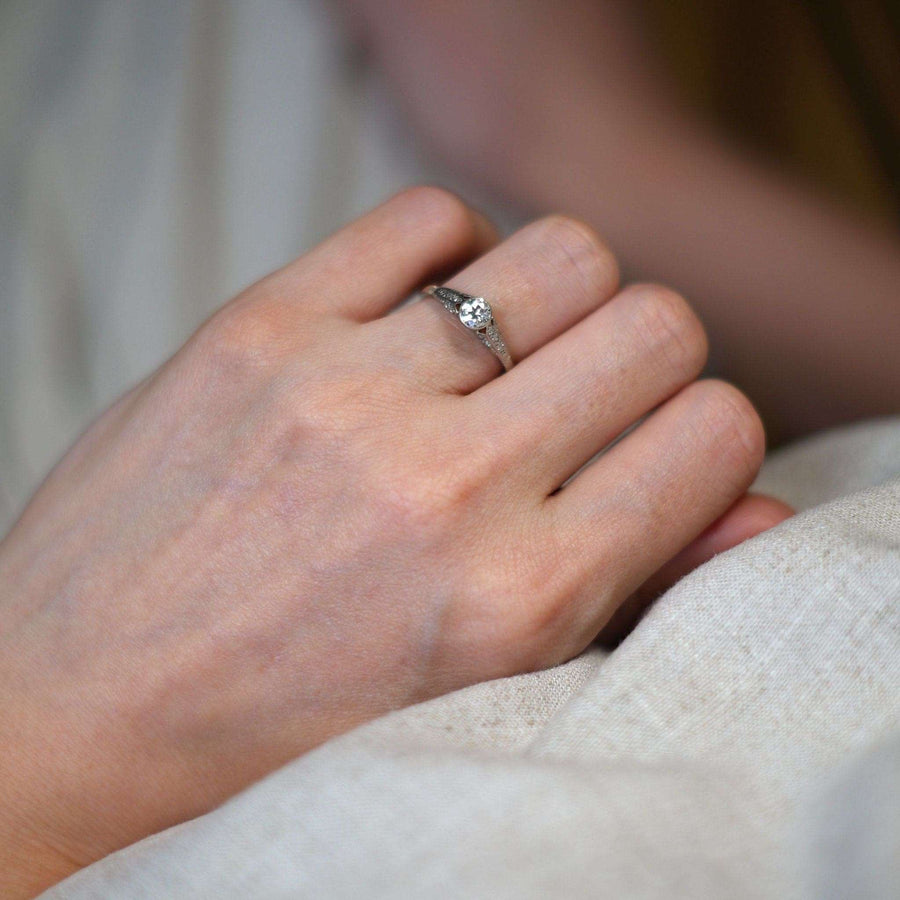 Art Deco 18ct gold and diamond solitaire ring worn on hand, showcasing vintage elegance and intricate design.