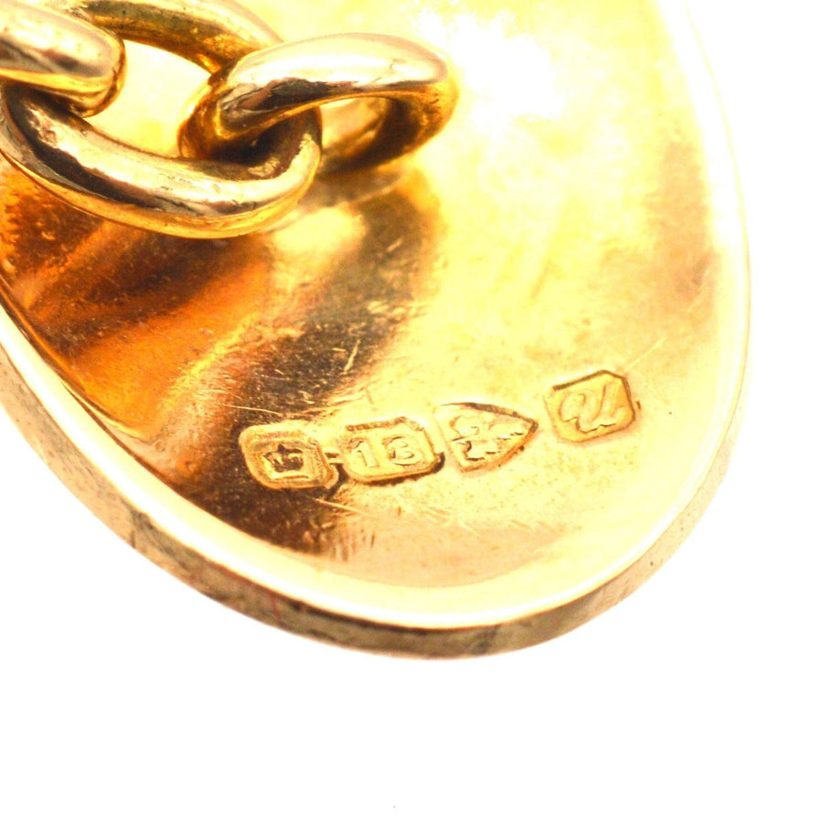Close-up of 18ct gold oval cufflinks showing Chester hallmark and chain detail, showcasing Art Deco craftsmanship.