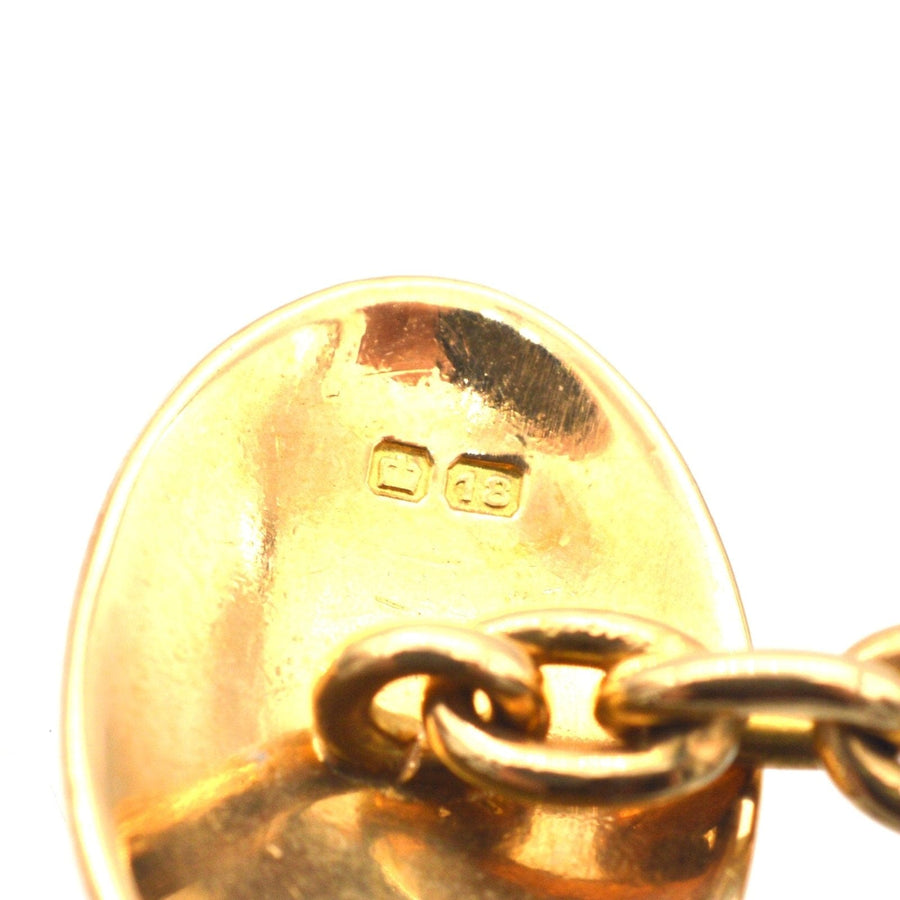 Close-up of the back of Art Deco 18ct gold plain oval cufflinks, showing hallmark and chain detail.