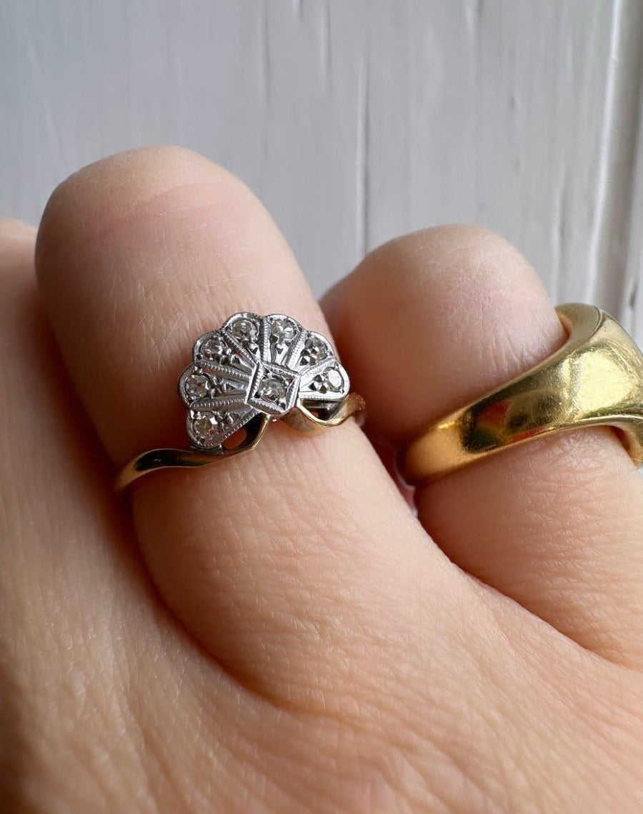 Art Deco 18ct gold and platinum diamond fan ring worn on a finger, showcasing intricate design and sparkle.