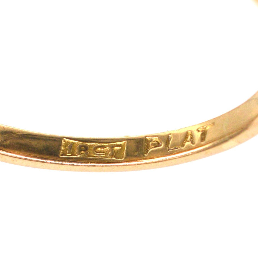 Close-up of the hallmark on an 18ct gold and platinum ring, indicating quality and authenticity.