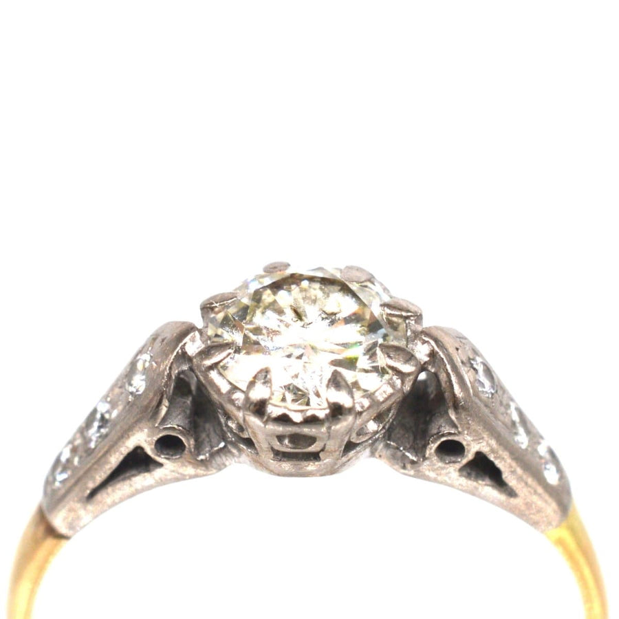 Art Deco 18ct gold and platinum diamond solitaire ring with diamond shoulders, featuring a large central diamond.