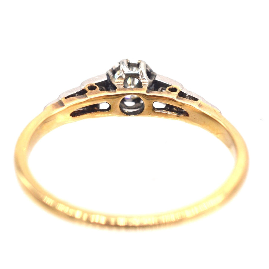 Art Deco 18ct gold and platinum diamond solitaire ring with diamond shoulders, showcasing elegant design.