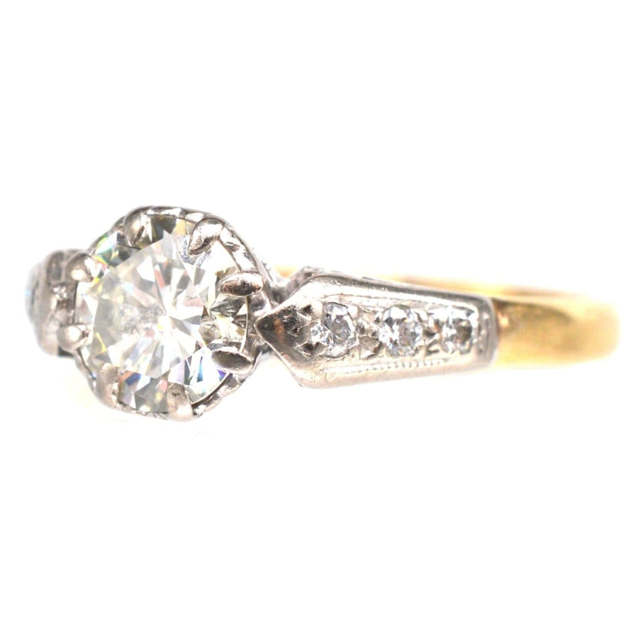 Art Deco 18ct gold and platinum diamond solitaire ring with diamond shoulders, featuring a large central diamond.