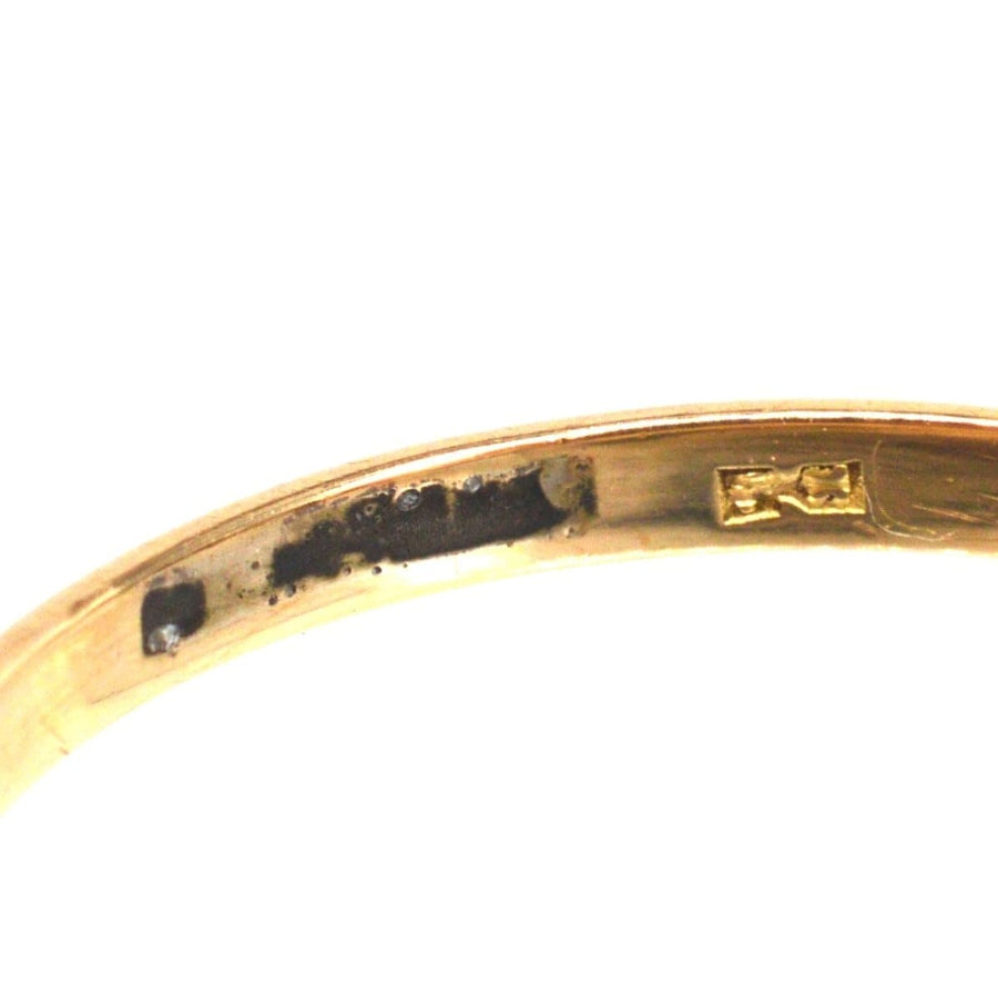 Close-up view of the inner band of an Art Deco 18ct Gold & Platinum diamond solitaire ring.